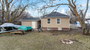 Rear view of house with a lawn