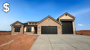 View of front of home with brick siding, an attached garage, driveway, and board and batten siding