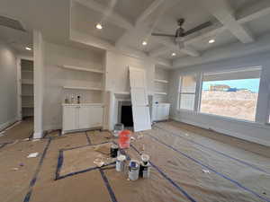 Unfurnished living room featuring coffered ceiling, a ceiling fan, recessed lighting, and beam ceiling
