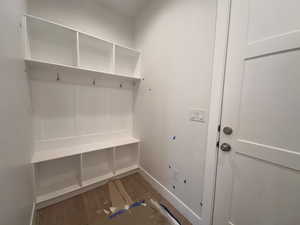 Mudroom featuring wood finished floors and baseboards