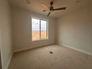 Unfurnished room featuring light carpet and a ceiling fan