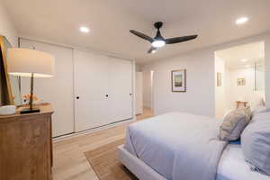 Bedroom featuring a closet, ceiling fan, and light wood-type flooring