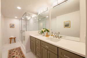 Bathroom featuring walk in shower and vanity