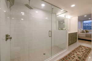 Bathroom with vanity and a shower with shower door