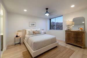 Bedroom featuring a mountain view, ceiling fan, and light wood-type flooring