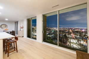 Dining space with expansive windows and hardwood / wood-style floors