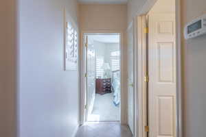 Hall featuring light tile patterned flooring