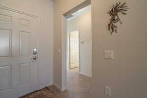 Foyer featuring light tile patterned floors