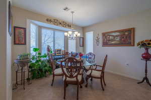 Tiled dining room featuring a chandelier