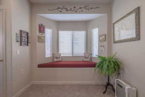 Interior space with radiator and light tile patterned floors