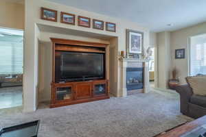 Carpeted living room with a fireplace