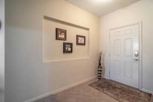 Doorway to outside with tile patterned flooring