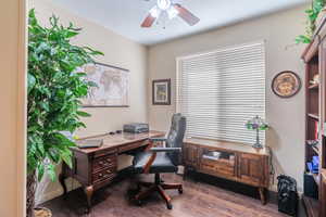 Office space featuring ceiling fan and dark hardwood / wood-style flooring