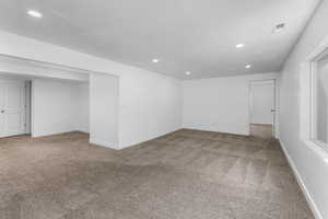 Interior space featuring recessed lighting, visible vents, and baseboards