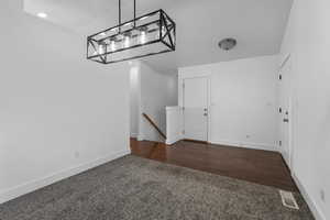 Garage featuring visible vents and baseboards