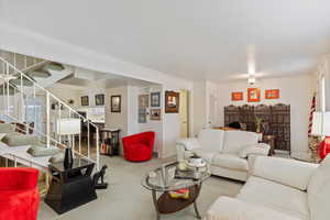 Living room featuring crown molding and light colored carpet