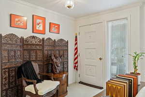 Sitting room featuring crown molding and carpet floors