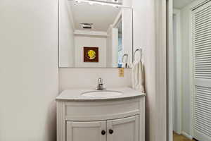 Bathroom featuring vanity and crown molding