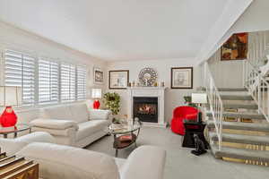 Living room with ornamental molding and carpet floors