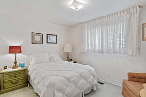 Bedroom featuring light colored carpet