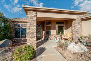 View of exterior entry featuring a patio