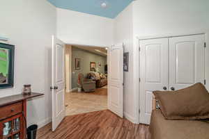 Hall with hardwood / wood-style floors