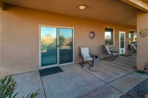 Doorway to property featuring a patio area