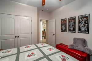 Bedroom with ceiling fan and a closet