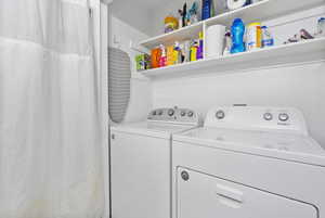 Laundry room featuring washing machine and clothes dryer