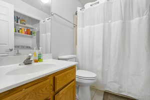 Bathroom featuring tile patterned floors, vanity, and toilet