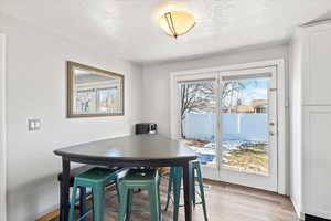 Dining room featuring a textured ceiling and light wood-type flooring