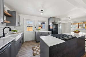 Kitchen featuring sink, a wealth of natural light, stainless steel appliances, and a kitchen island