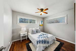 Bedroom featuring dark wood-type flooring and ceiling fan