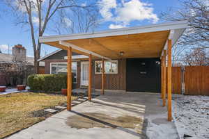 View of patio with a carport