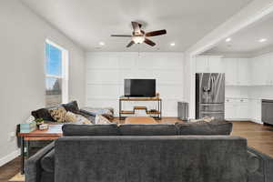 Living room featuring ceiling fan and dark hardwood / wood-style flooring