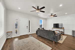 Living room featuring dark hardwood / wood-style flooring and ceiling fan