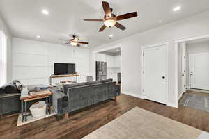 Living room featuring dark hardwood / wood-style flooring and ceiling fan