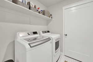 Clothes washing area featuring washer and clothes dryer