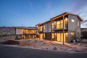 Contemporary house featuring a mountain view, a balcony, and central air condition unit