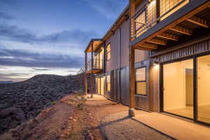 Property exterior at dusk featuring a mountain view and a balcony