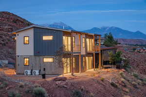 Rear view of house featuring a balcony, a mountain view, and ac unit