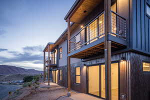 View of side of home with a balcony and a mountain view