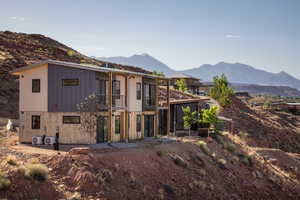 Back of property with a balcony and a mountain view