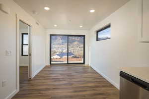 Hall featuring dark wood-type flooring