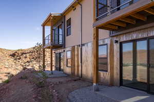 View of side of property with a balcony