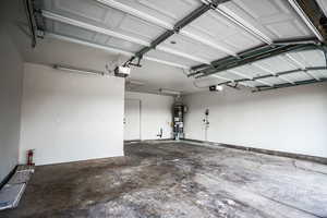 Garage with a garage door opener and gas water heater