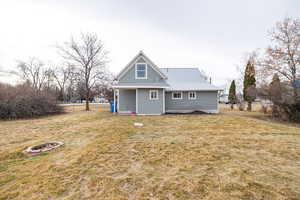 Rear view of property with a lawn