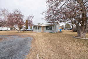 View of front of house featuring a porch and a front yard