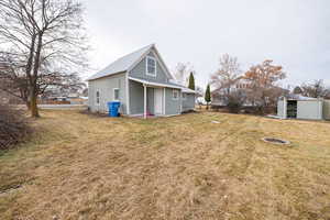 Back of house featuring a yard