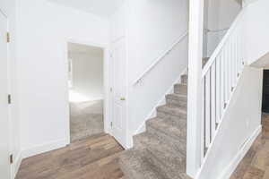 Staircase with hardwood / wood-style flooring